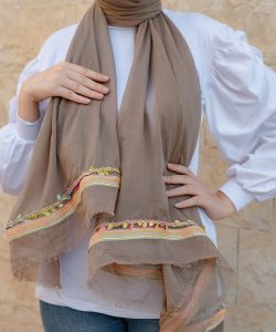 A coffe soft cotton scarf with a colorful trim.